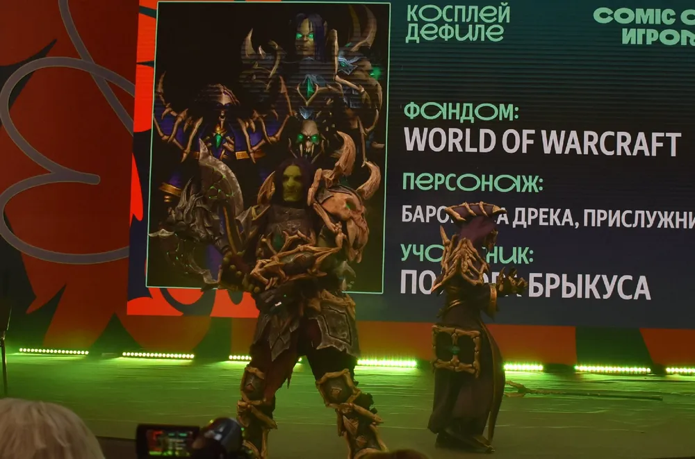 Изображение косплея персонажей из игры World of Warcraft на мероприятии, включая детали костюмов и участников.