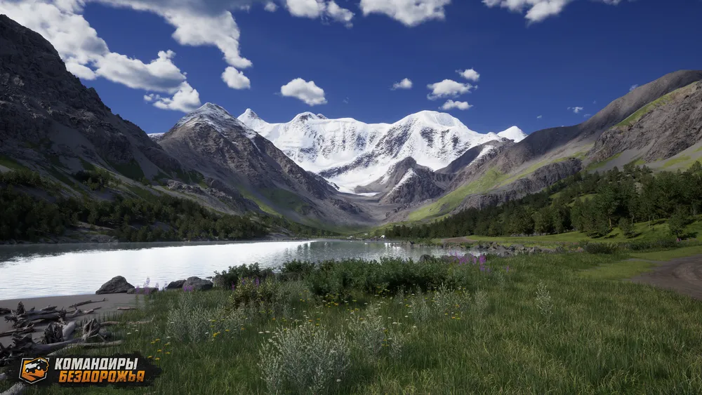 Пейзаж с горами, рекой и зелёной растительностью.